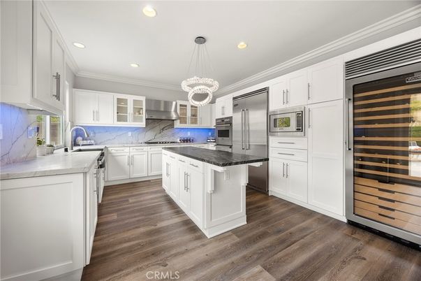 Interior, Kitchen, Marble Walls, Pendant Lights, Recessed Lighting, Stainless Steel Appliances, Wood Texture Flooring
