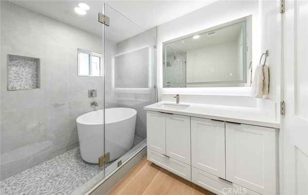 Bathroom, Free Standing Baths, Glass Shower, Interior, Recessed Lighting, Wood Texture Flooring