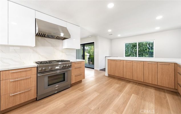 Interior, Kitchen, Marble Walls, Recessed Lighting, Stainless Steel Appliances, Wood Texture Flooring