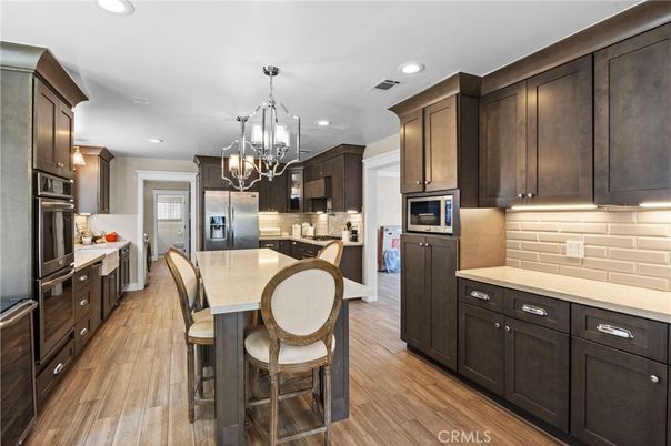 Chandelier, Interior, Kitchen, Pendant Lights, Recessed Lighting, Stainless Steel Appliances, Wood Texture Flooring