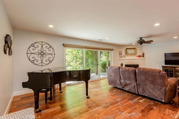 Fireplace, Interior, Living room, Piano, Recessed Lighting, Wood Texture Flooring