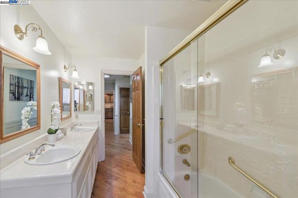 Bathroom, Dual Sink Vanities, Glass Shower, Interior, Tile Countertops, Wood Texture Flooring