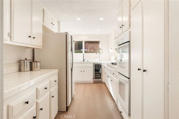 Interior, Kitchen, Recessed Lighting, Tile Countertops, Wood Texture Flooring