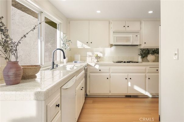 Interior, Kitchen, Recessed Lighting, Tile Countertops, Wood Texture Flooring