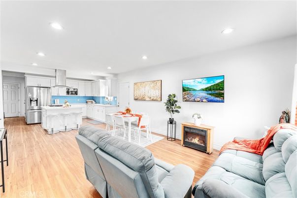 Dining room, Fireplace, Interior, Kitchen, Living room, Recessed Lighting, Stainless Steel Appliances, Wood Texture Flooring