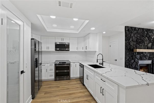 Fireplace, Interior, Kitchen, Recessed Lighting, Stainless Steel Appliances, Wood Texture Flooring