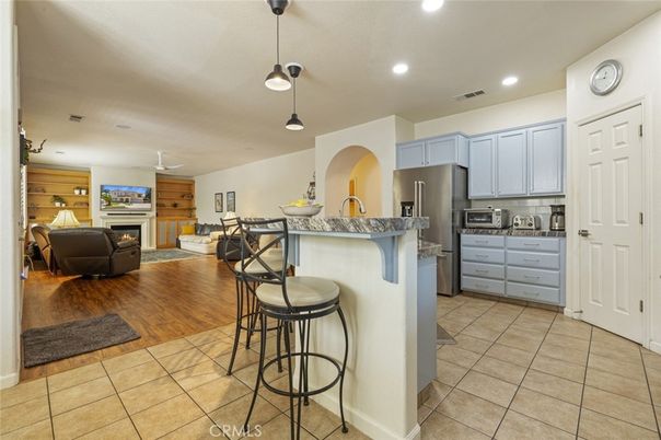 Fireplace, Interior, Kitchen, Living room, Pendant Lights, Recessed Lighting, Stainless Steel Appliances, Wood Texture Flooring