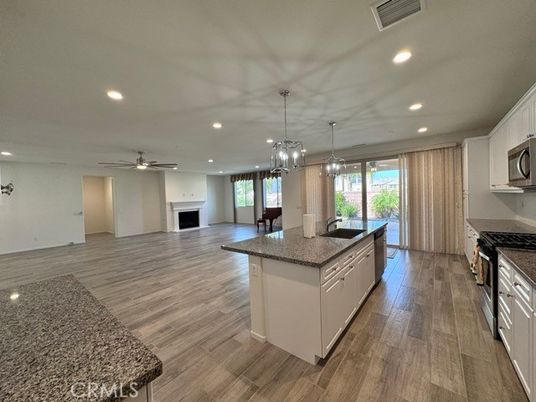 Chandelier, Fireplace, Interior, Kitchen, Pendant Lights, Recessed Lighting, Wood Texture Flooring