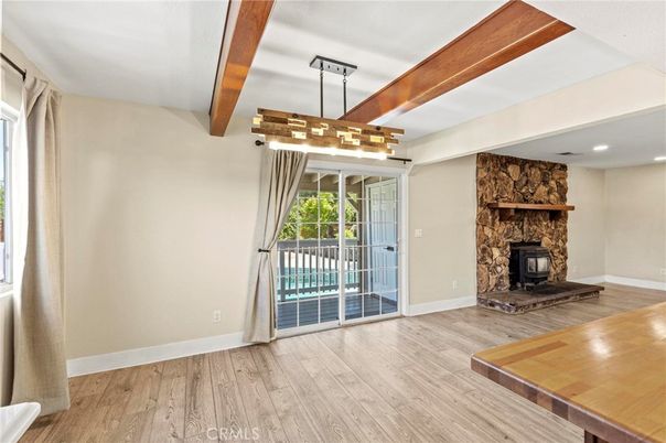Empty room, Fireplace, Interior, Pendant Lights, Recessed Lighting, Stone Walls, Wooden Beams, Wood Texture Flooring