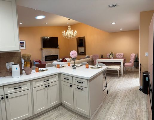 Chandelier, Dining room, Fireplace, Interior, Living room, Recessed Lighting, Wood Texture Flooring
