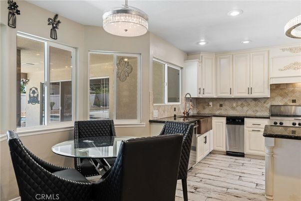 Chandelier, Dining room, Interior, Kitchen, Pendant Lights, Recessed Lighting, Stainless Steel Appliances, Wood Texture Flooring