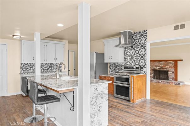 Fireplace, Interior, Kitchen, Recessed Lighting, Stainless Steel Appliances, Wood Texture Flooring