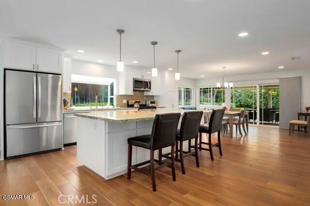 Dining room, Interior, Kitchen, Pendant Lights, Recessed Lighting, Stainless Steel Appliances, Wood Texture Flooring