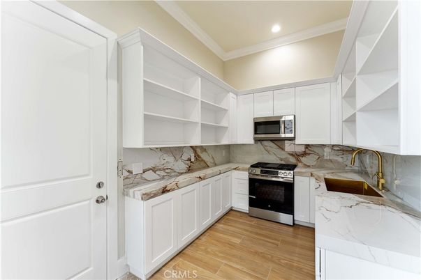 Interior, Kitchen, Marble Walls, Recessed Lighting, Stainless Steel Appliances, Wood Texture Flooring