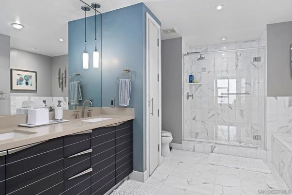Bathroom, Dual Sink Vanities, Glass Shower, Interior, Marble, Marble Walls, Pendant Lights, Recessed Lighting