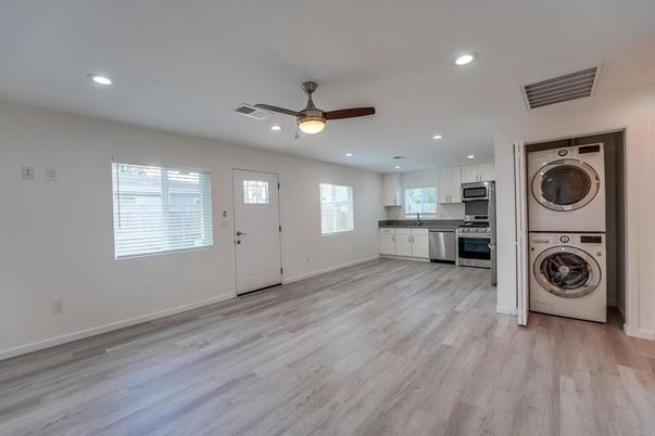 Interior, Kitchen, Recessed Lighting, Stainless Steel Appliances, Washer, Wood Texture Flooring