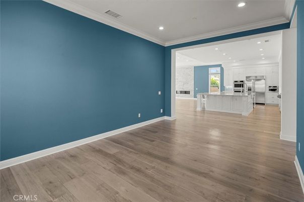 Empty room, Interior, Kitchen, Recessed Lighting, Stainless Steel Appliances, Wood Texture Flooring