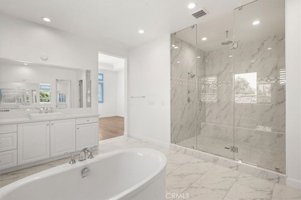 Bathroom, Dual Sink Vanities, Free Standing Baths, Glass Shower, Interior, Marble, Marble Walls, Recessed Lighting, Wood Texture Flooring