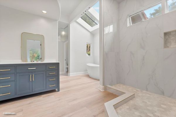 Bathroom, Free Standing Baths, Interior, Marble Walls, Recessed Lighting, Wood Texture Flooring