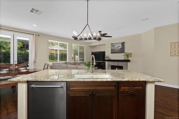 Chandelier, Dining room, Fireplace, Interior, Kitchen, Living room, Recessed Lighting, Stainless Steel Appliances, Wood Texture Flooring