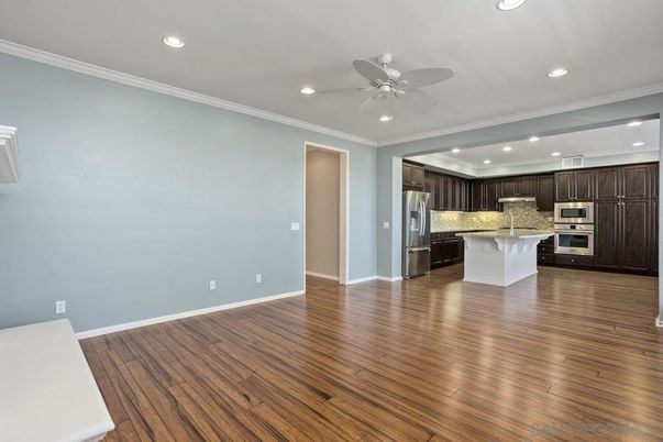 Empty room, Interior, Kitchen, Recessed Lighting, Stainless Steel Appliances, Wood Texture Flooring