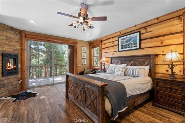 Bedroom, Fireplace, Interior, Recessed Lighting, Wood Texture Flooring, Wooden Walls