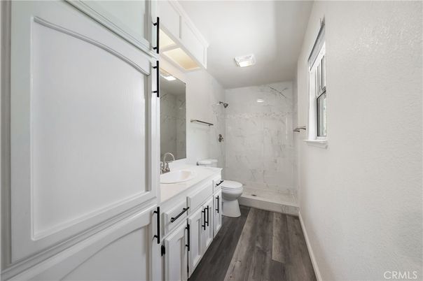 Bathroom, Dual Sink Vanities, Glass Shower, Interior, Marble Walls, Wood Texture Flooring