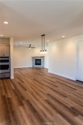 Empty room, Fireplace, Interior, Kitchen, Pendant Lights, Recessed Lighting, Wood Texture Flooring