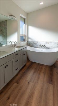 Bathroom, Dual Sink Vanities, Free Standing Baths, Interior, Marble Walls, Recessed Lighting, Wood Texture Flooring