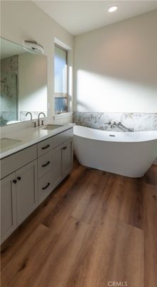 Bathroom, Dual Sink Vanities, Free Standing Baths, Interior, Marble Walls, Recessed Lighting, Wood Texture Flooring