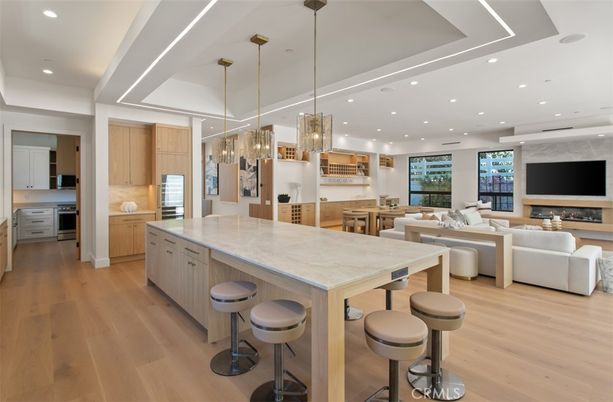 Fireplace, Interior, Kitchen, Living room, Pendant Lights, Recessed Lighting, Stainless Steel Appliances, Wood Texture Flooring