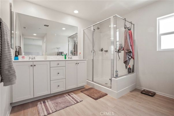 Bathroom, Dual Sink Vanities, Glass Shower, Interior, Recessed Lighting, Wood Texture Flooring