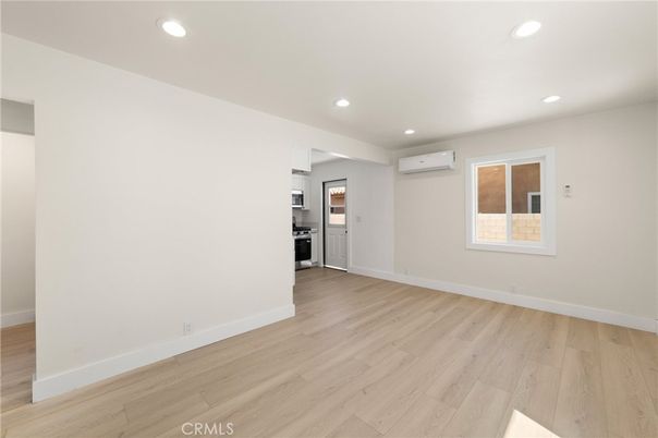 Empty room, Interior, Kitchen, Recessed Lighting, Stainless Steel Appliances, Wood Texture Flooring
