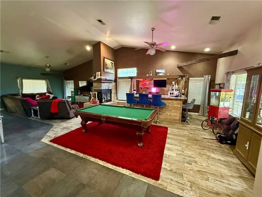 Billiard Table, Fireplace, Game Room, Interior, Living room, Recessed Lighting, Stone Walls, Wood Texture Flooring