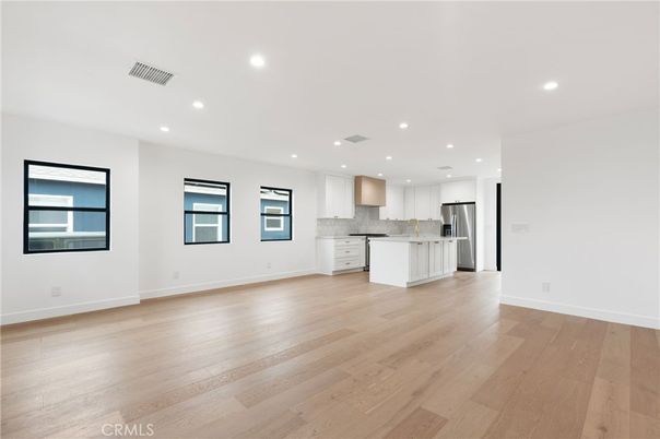 Empty room, Interior, Kitchen, Recessed Lighting, Stainless Steel Appliances, Wood Texture Flooring