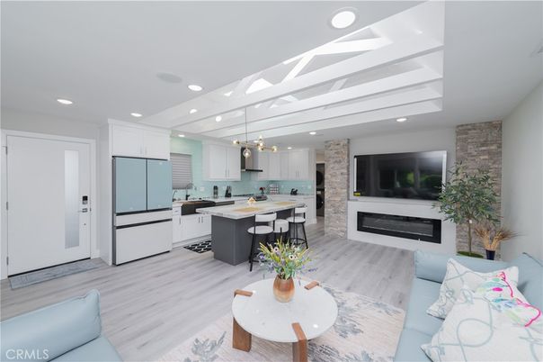 Fireplace, Interior, Kitchen, Living room, Pendant Lights, Recessed Lighting, Stainless Steel Appliances, Stone Walls, Wood Texture Flooring