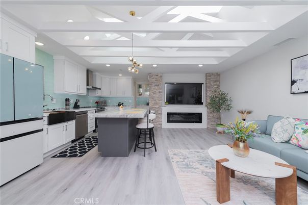 Fireplace, Interior, Kitchen, Living room, Pendant Lights, Recessed Lighting, Stainless Steel Appliances, Stone Walls, Wood Texture Flooring