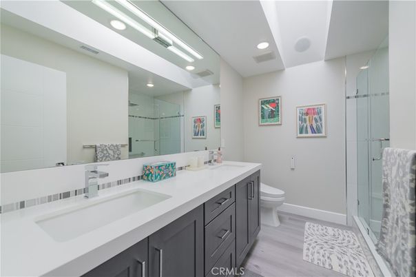 Bathroom, Dual Sink Vanities, Glass Shower, Interior, Recessed Lighting, Wood Texture Flooring