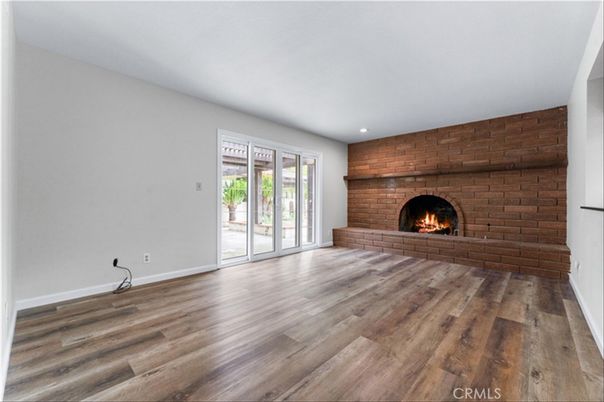 Empty room, Fireplace, Interior, Recessed Lighting, Stone Walls, Wood Texture Flooring