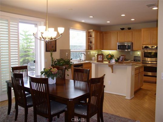 Chandelier, Dining room, Interior, Kitchen, Pendant Lights, Recessed Lighting, Stainless Steel Appliances, Wood Texture Flooring