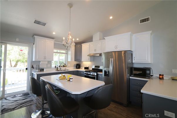 Chandelier, Interior, Kitchen, Pendant Lights, Recessed Lighting, Stainless Steel Appliances, Wood Texture Flooring