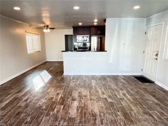 Empty room, Interior, Kitchen, Recessed Lighting, Stainless Steel Appliances, Wood Texture Flooring