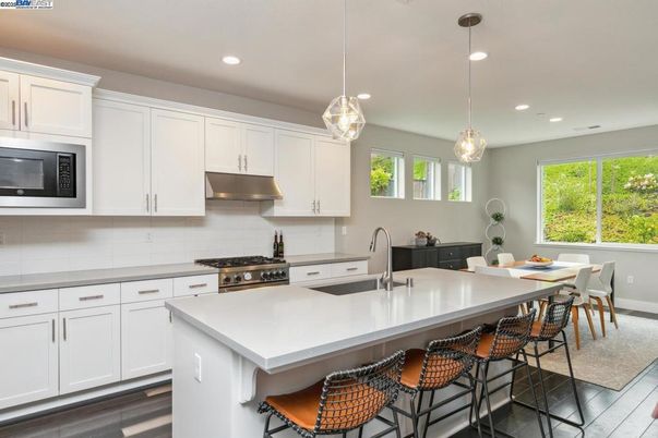 Dining room, Interior, Kitchen, Pendant Lights, Recessed Lighting, Stainless Steel Appliances, Wood Texture Flooring
