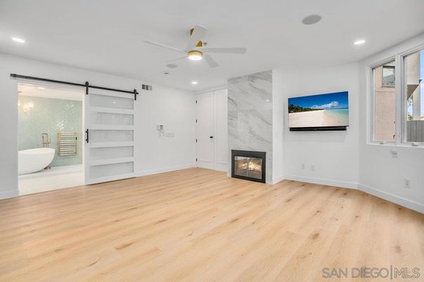 Bathroom, Empty room, Fireplace, Interior, Marble Walls, Recessed Lighting, Wood Texture Flooring