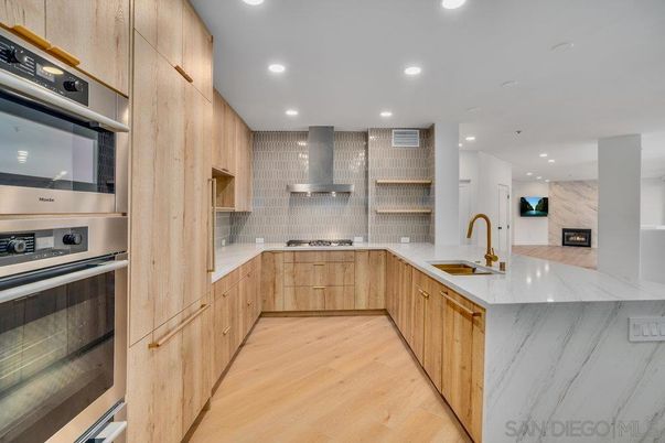 Interior, Kitchen, Marble Walls, Recessed Lighting, Stainless Steel Appliances, Wood Texture Flooring