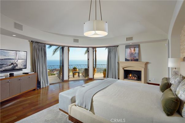 Bedroom, Fireplace, Interior, Pendant Lights, Recessed Lighting, Water, Wood Texture Flooring