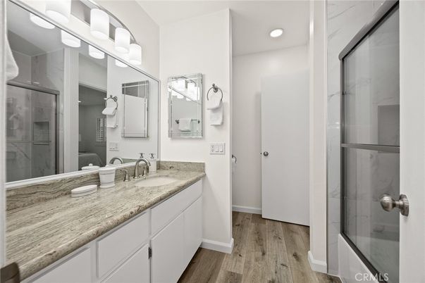 Bathroom, Dual Sink Vanities, Glass Shower, Interior, Recessed Lighting, Wood Texture Flooring