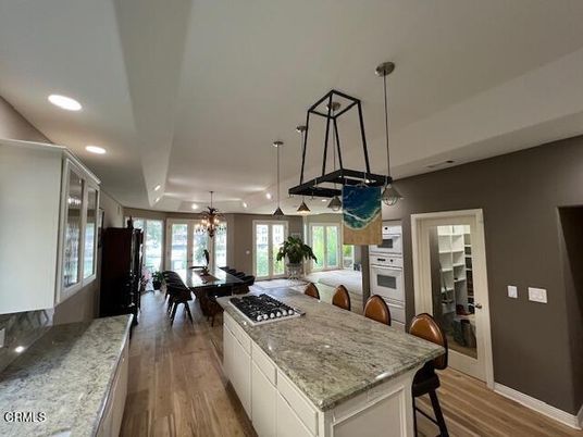 Chandelier, Dining room, Interior, Kitchen, Pendant Lights, Recessed Lighting, Stainless Steel Appliances, Wood Texture Flooring
