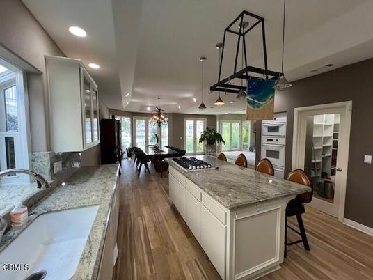 Chandelier, Dining room, Interior, Kitchen, Pendant Lights, Recessed Lighting, Stainless Steel Appliances, Wood Texture Flooring