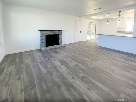 Empty room, Fireplace, Interior, Kitchen, Pendant Lights, Recessed Lighting, Wood Texture Flooring